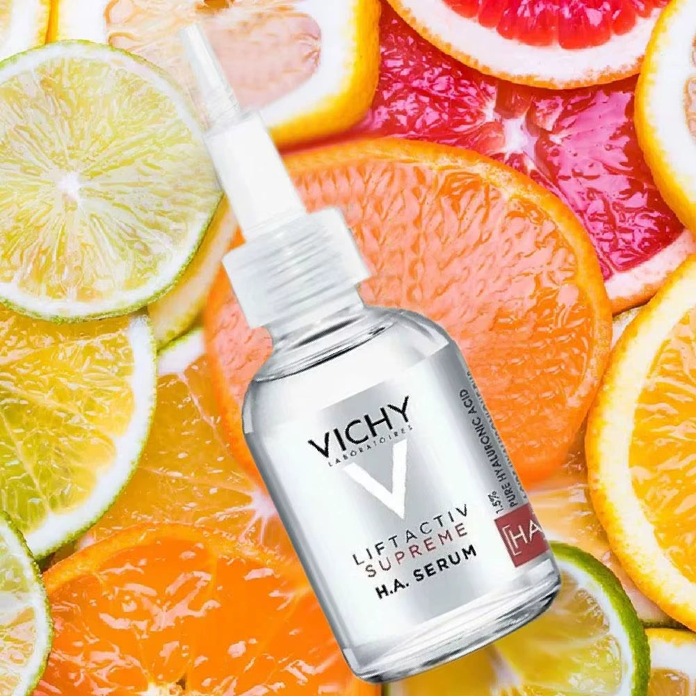 Vichy Liftactiv Supreme HA Serum bottle on a background of sliced citrus fruits