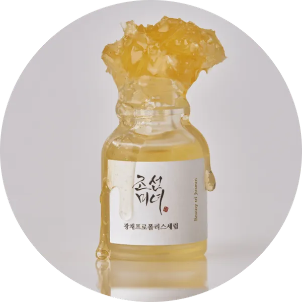 Frasco de Glow Serum con panal de miel